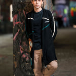 Person leaning against a graffiti-covered wall in an urban setting
