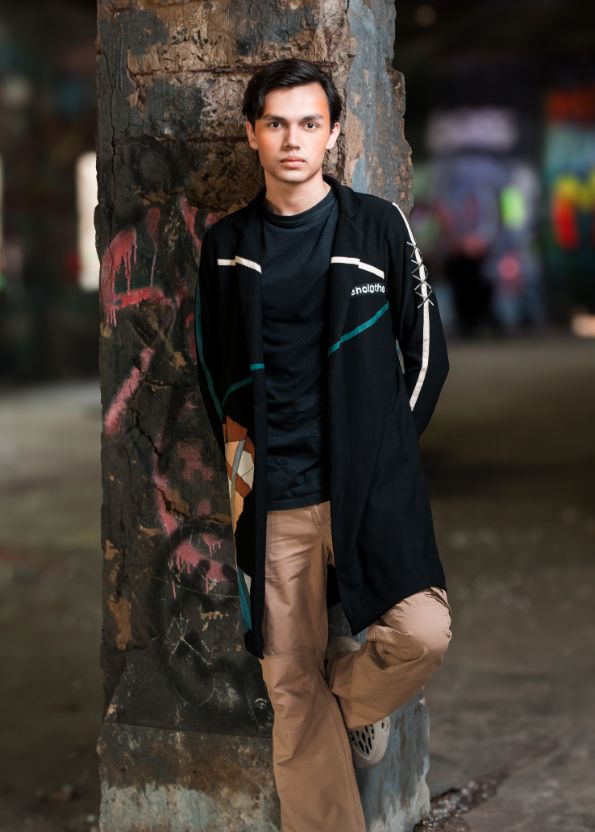 Person leaning against a graffiti-covered wall in an urban setting