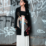 Woman standing in front of a graffiti-covered wall