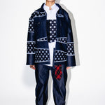 Person wearing a patterned outfit with a white background