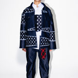 Person wearing a patterned outfit with a white background