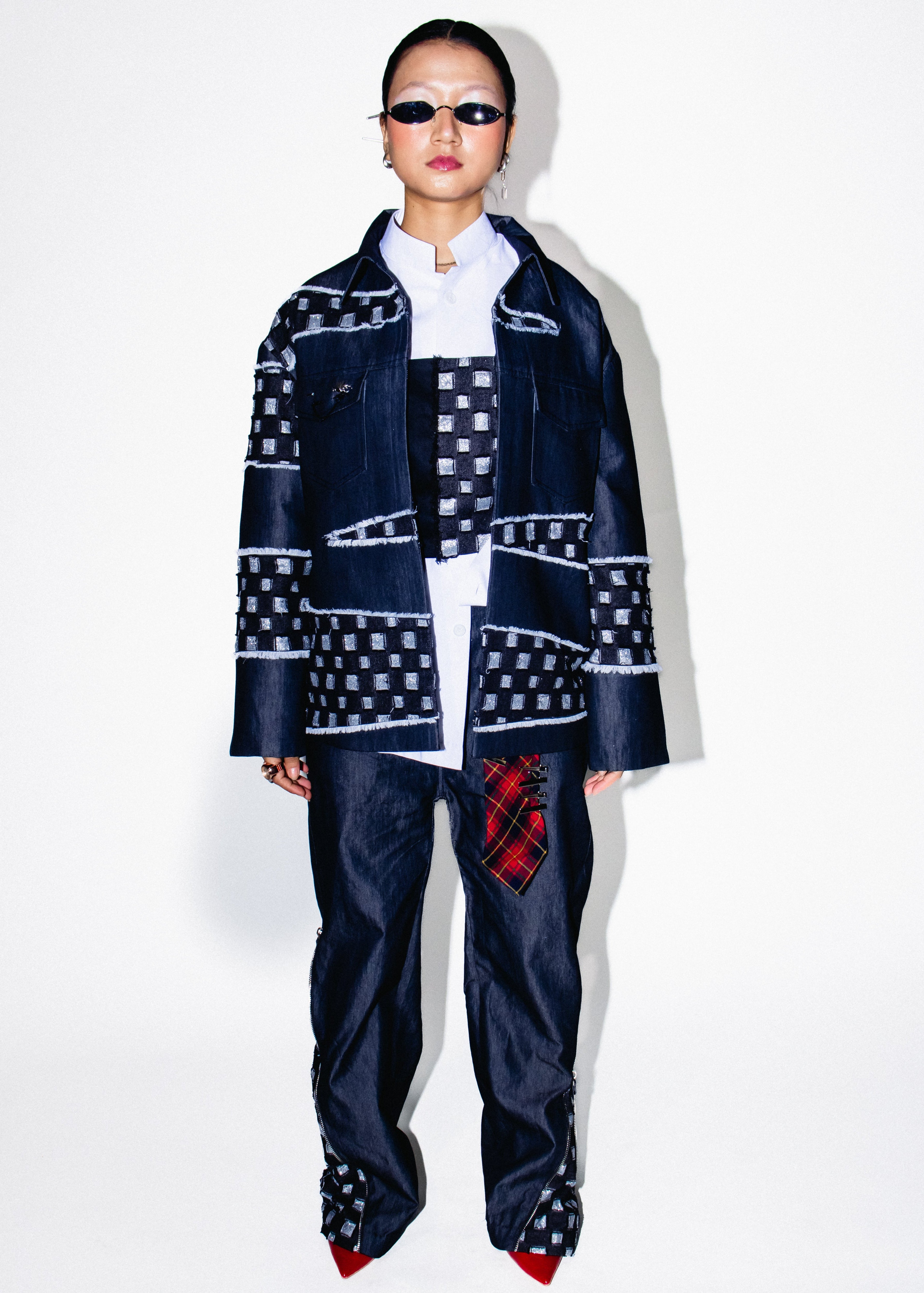 Person wearing a patterned outfit with a white background