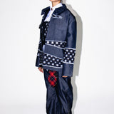Person wearing a unique outfit with a denim jacket and plaid pants on a white background