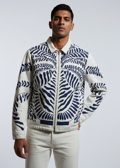 Man wearing a patterned jacket on a plain background