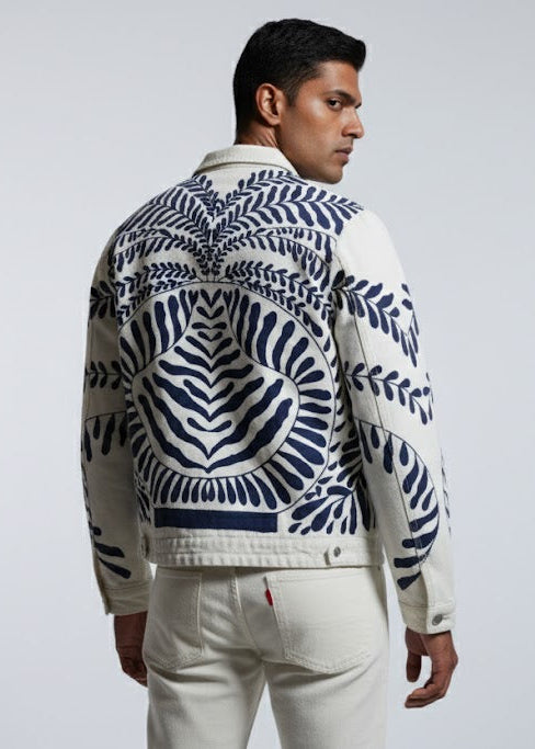 Man wearing a patterned jacket on a plain background