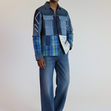 Man wearing a plaid shirt and jeans on a plain background