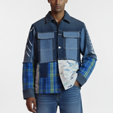 Man wearing a patchwork jacket and jeans on a white background