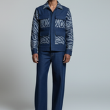 Man wearing a blue patterned outfit on a white background