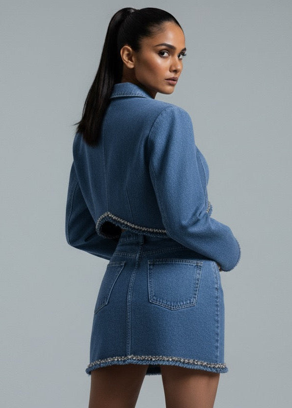 Woman wearing a blue denim outfit on a gray background
