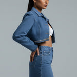 Woman wearing a denim outfit on a gray background
