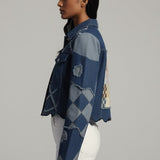 Person wearing a blue patterned shirt on a gray background