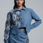 Woman wearing a blue floral outfit on a gray background