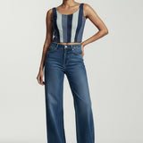 Woman wearing a striped top and blue jeans on a white background
