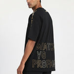 Man wearing a black t-shirt with text on a white background