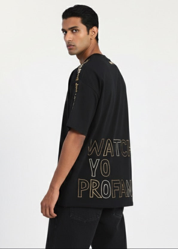 Man wearing a black t-shirt with text on a white background
