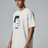 Man wearing a white t-shirt with text on a gray background