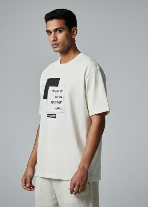 Man wearing a white t-shirt with text on a gray background