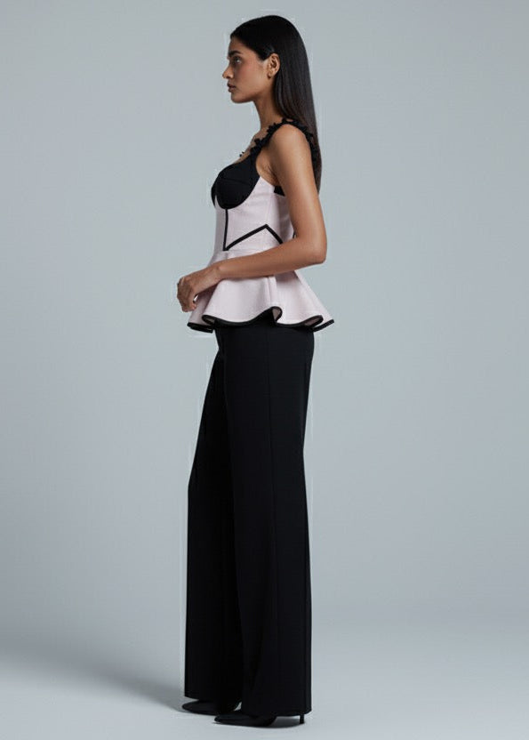 Woman wearing a black and white outfit on a gray background