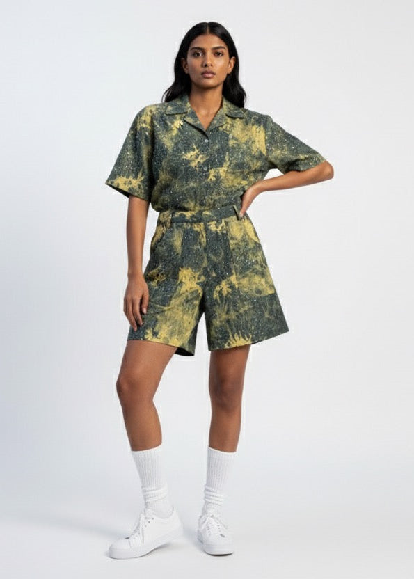 Woman wearing a green and yellow tie-dye outfit on a white background