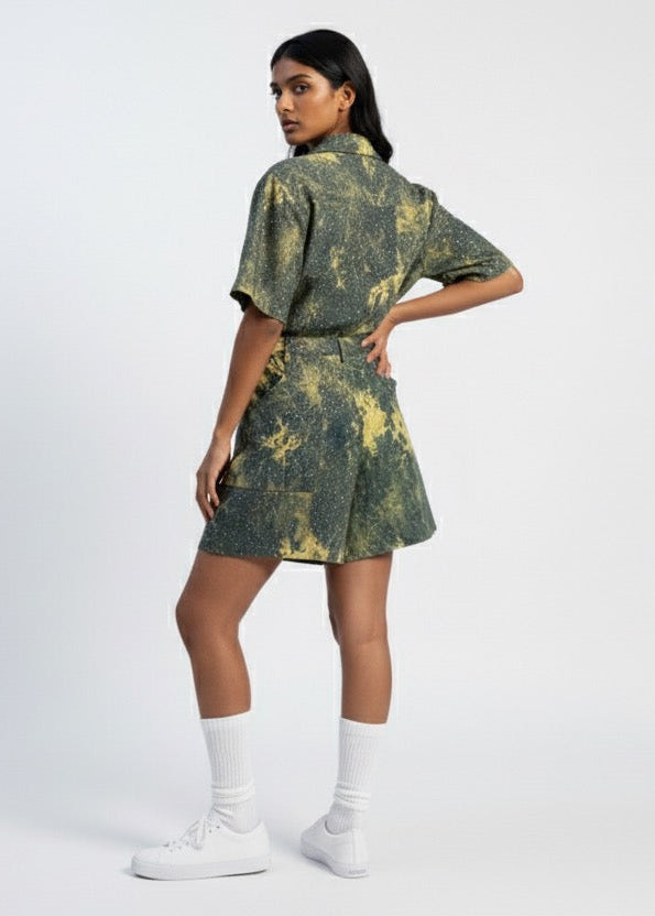 Woman wearing a green tie-dye outfit on a white background