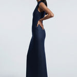 Woman wearing a navy blue dress against a white background