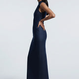 Woman wearing a navy blue dress against a white background