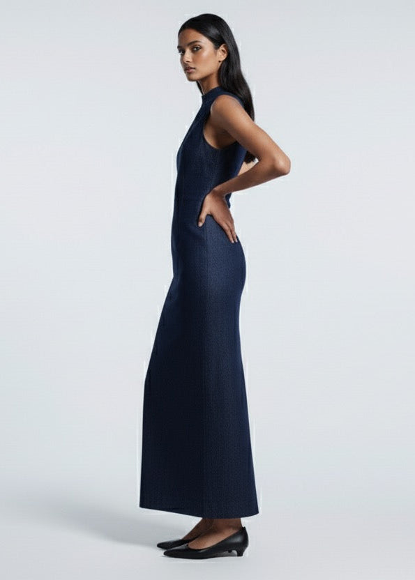 Woman wearing a navy blue dress against a white background