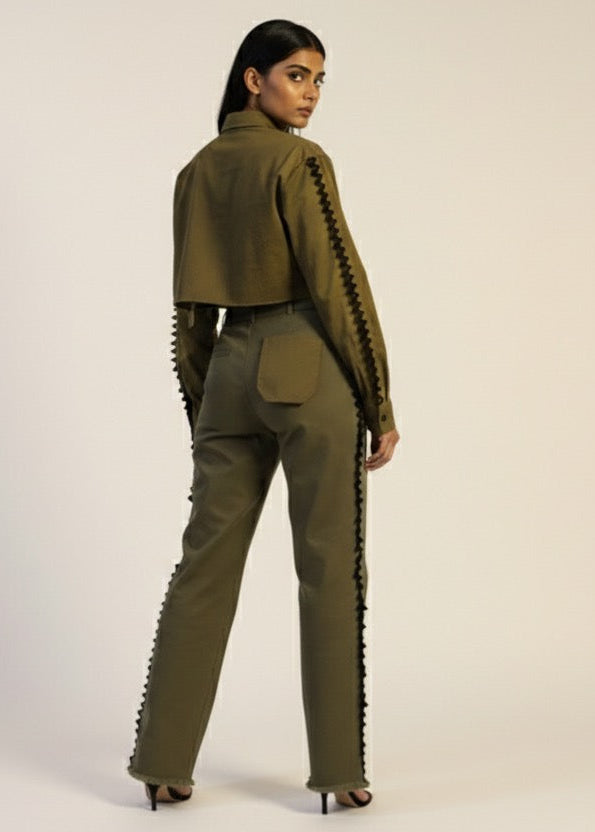 Woman wearing a green outfit with textured details on a white background