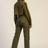 Woman wearing a green outfit with textured details on a white background