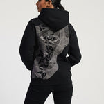 Person wearing a black hoodie with a geometric design on the back against a white background