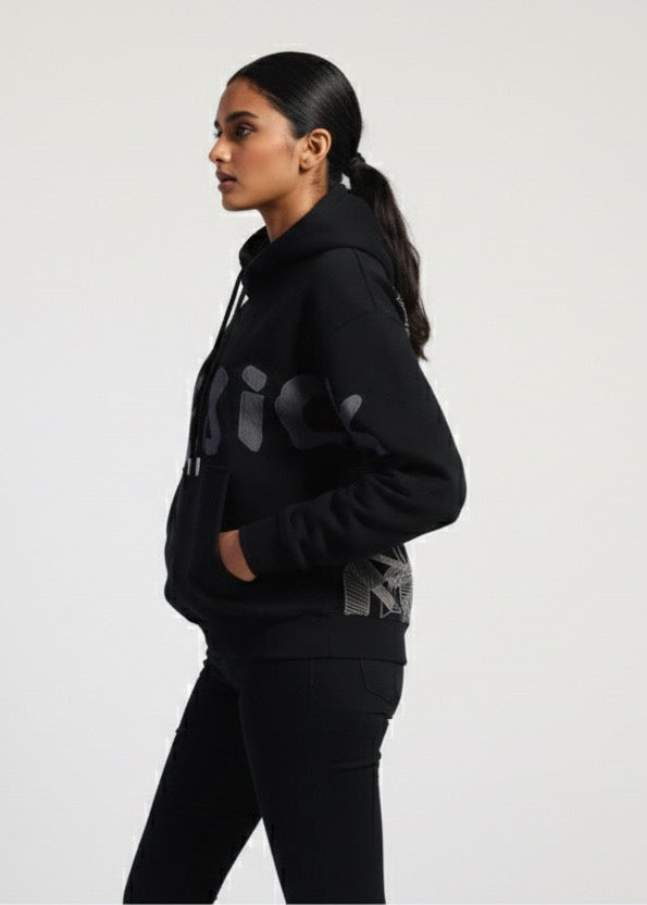 Person wearing a black hoodie with gray patterns on a white background
