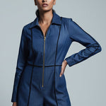Woman wearing a blue jacket against a gray background