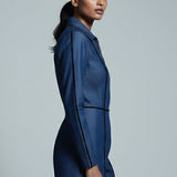 Woman wearing a blue outfit against a gray background