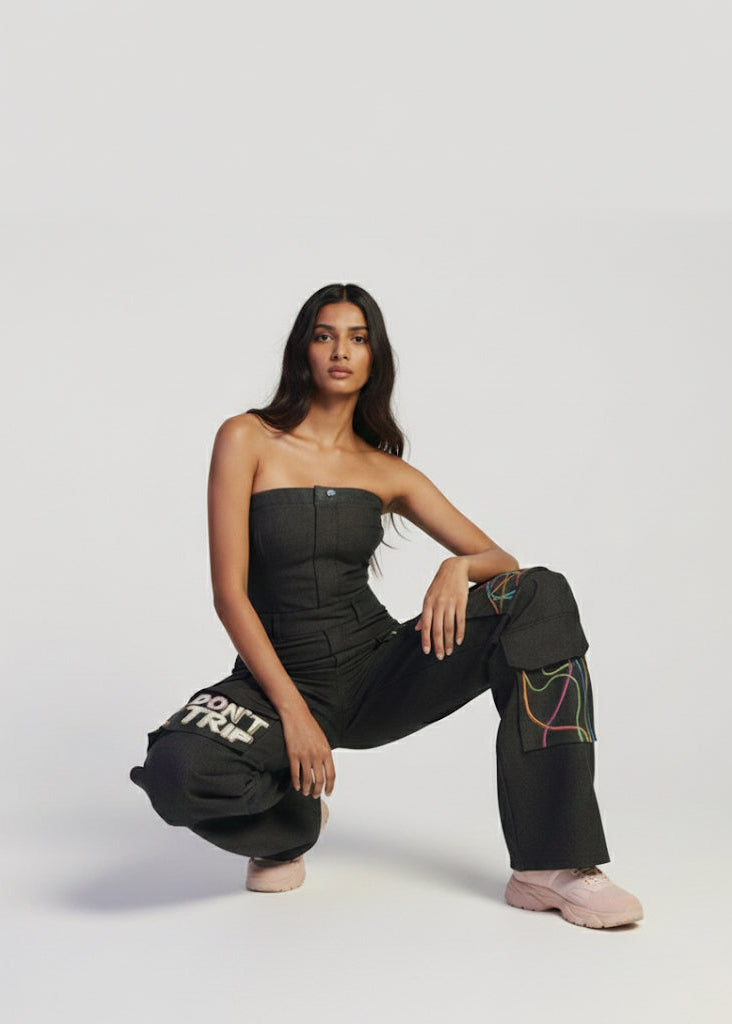 Woman wearing black pants with text and colorful designs on a white background