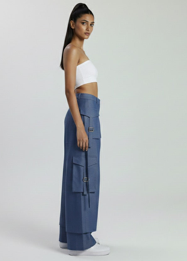 Woman wearing a white top and blue cargo pants on a white background