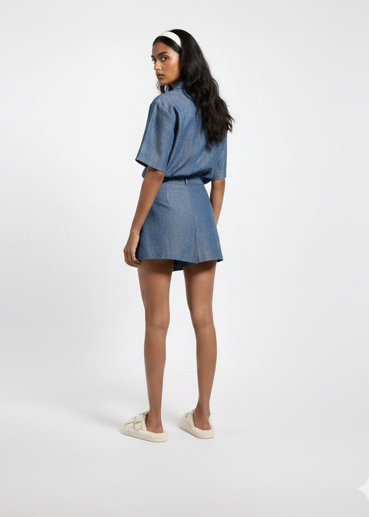 Woman wearing a denim outfit on a white background