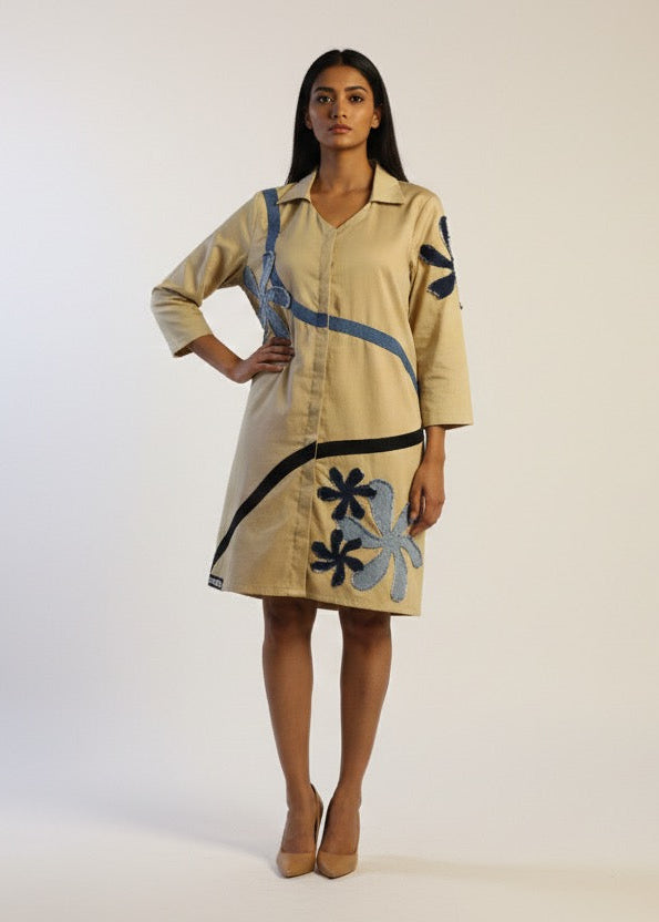 Woman wearing a beige dress with floral patterns on a white background