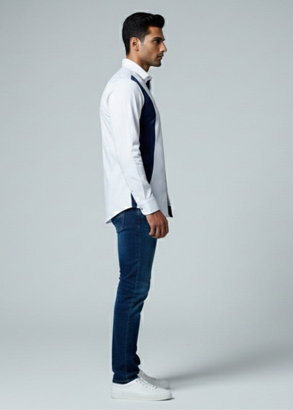Man wearing a white shirt, dark vest, and blue jeans on a gray background