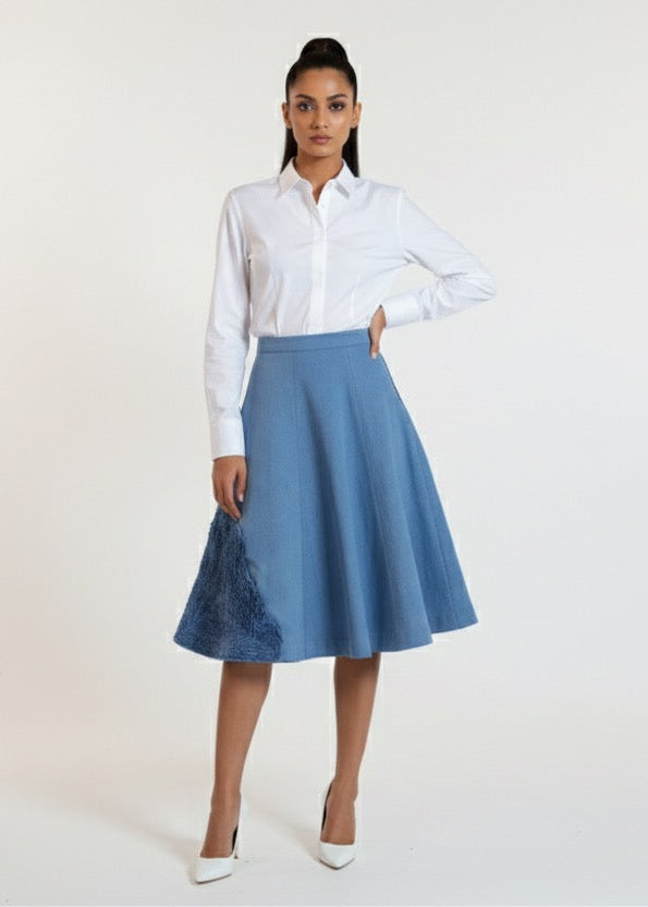 Woman wearing a white shirt and blue skirt on a white background