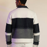 Person wearing a striped rugby shirt with a neutral background