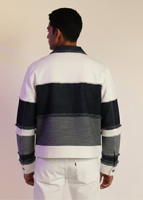 Person wearing a striped rugby shirt with a neutral background