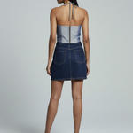 Woman wearing a denim dress with a white background
