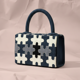 Handbag with puzzle pattern on a beige background