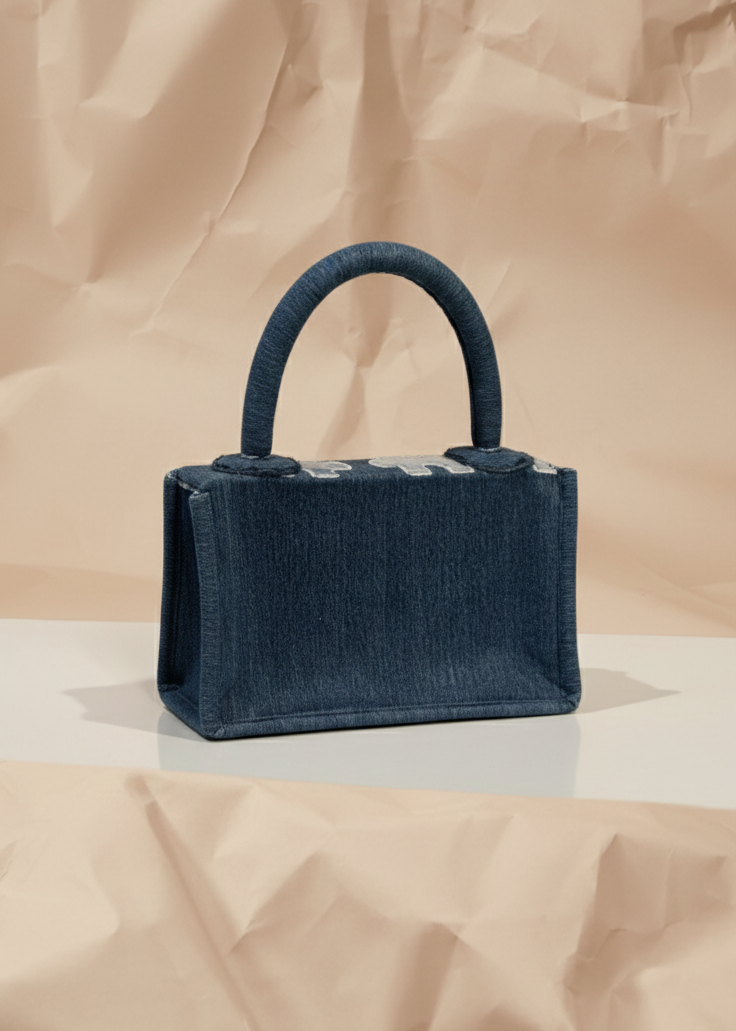 Navy blue handbag on a beige background