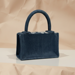 Navy blue handbag on a beige background