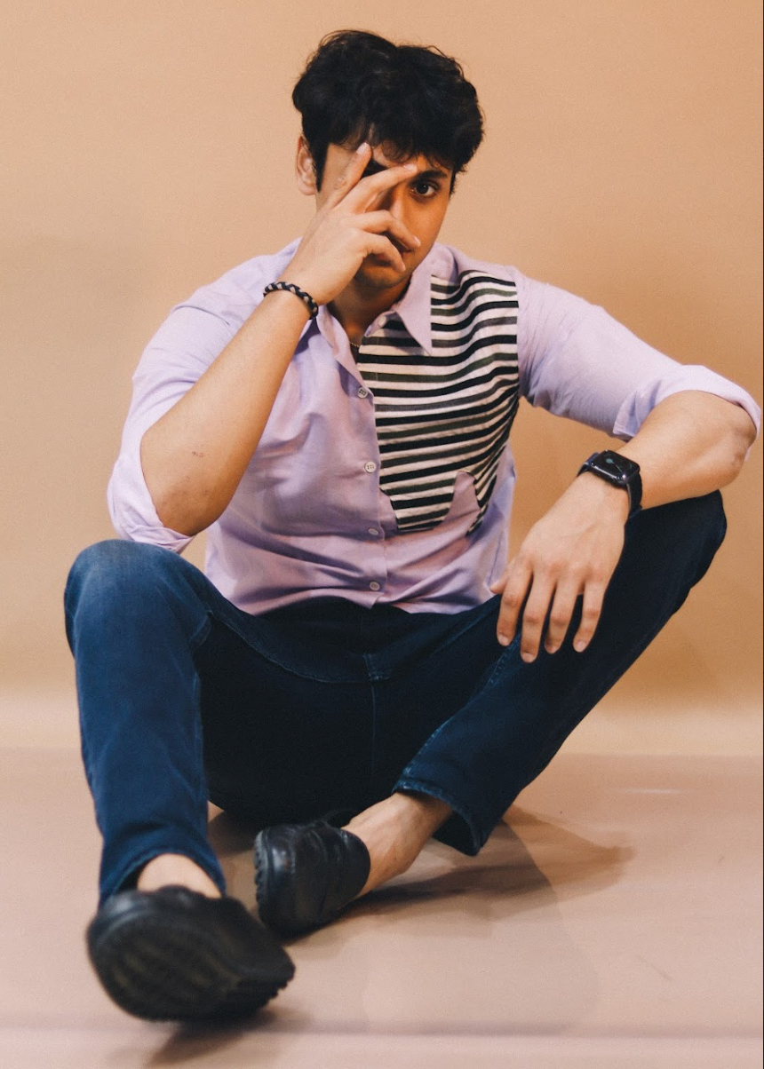 Person sitting on the floor with a neutral background