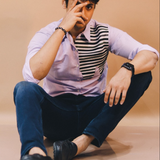 Person sitting on the floor with a neutral background