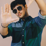 Man wearing sunglasses and a two-tone shirt with arms raised against a beige background